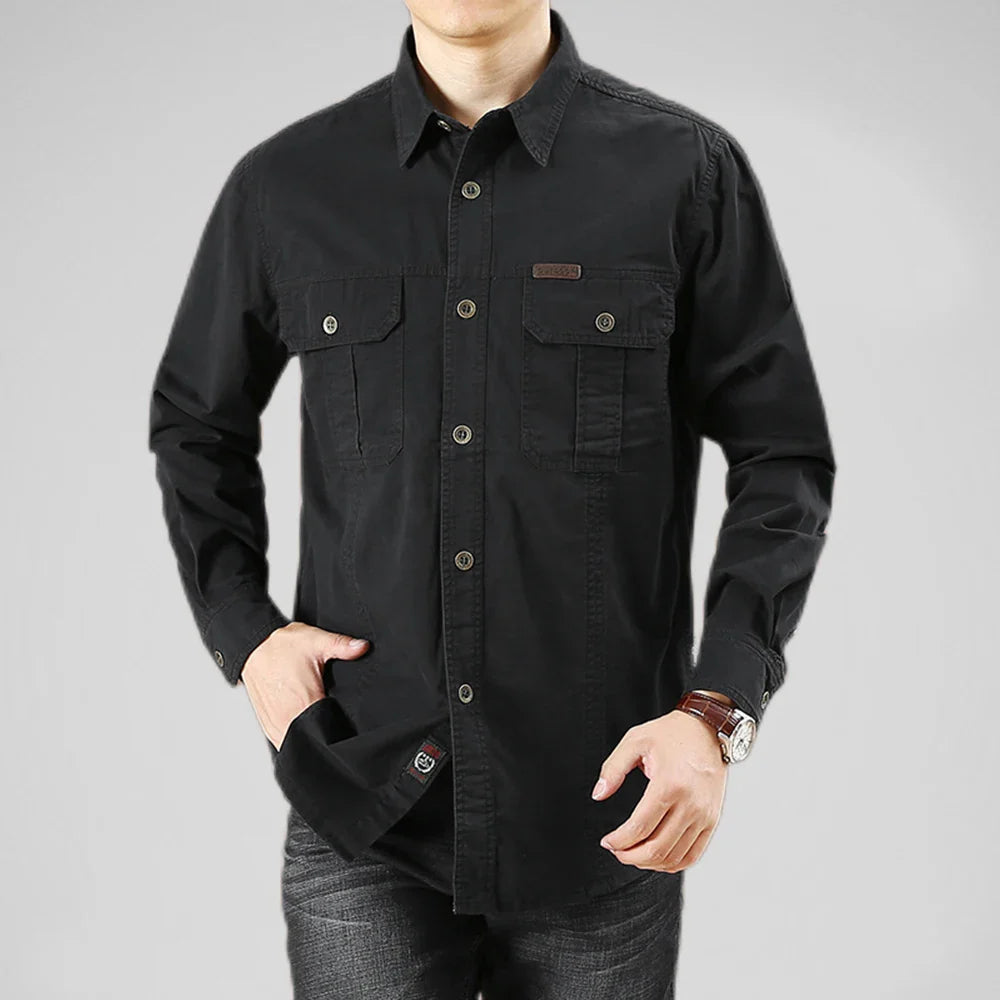 Black button-up shirt worn by a person on a gray background