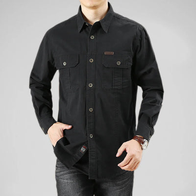 Black button-up shirt worn by a person on a gray background